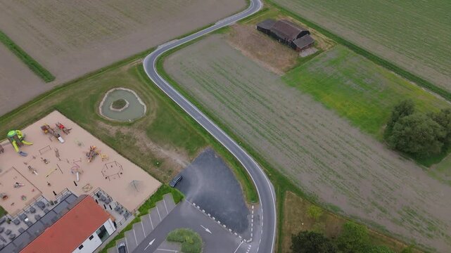 Aerial Top-Down of Curved Farm Road and Rustic Barn | FlyLens 4K