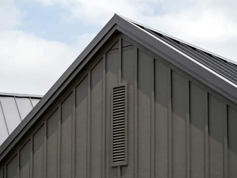 Modern gable roof with vertical cladding and ventilation grille - architectural detail