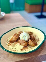 Pisang goreng aren topped with vanilla ice cream—warm, crispy, and sweetly indulgent, perfect for a comforting dessert fusion. Cisauk, Indonesia - May 12, 2025