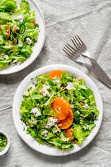 A light appetizer or an elegant side dish. Salad prepared with a mix of different varieties of leaves, enriched with orange slices, walnuts and pieces of cheese, feta, with a delicate flavor.