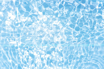 Blue water with ripples on the surface. Defocus blurred transparent blue colored clear calm water surface texture with splashes and bubbles. Water waves with shining pattern texture background.