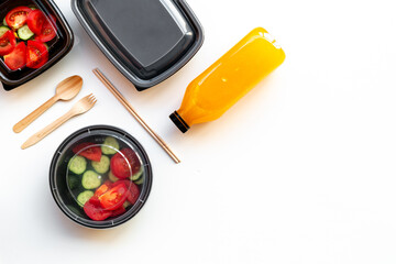 Tomatoes salad for lunch in plastic container ready for delivery, top view