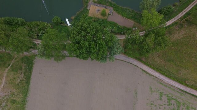 Top-Down Flyover from Fields to Lake Through Tree Line | FlyLens 4K
