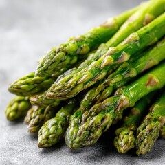 Fresh green asparagus spears close up on gray stone surface healthy eating concept macro shot studio shot