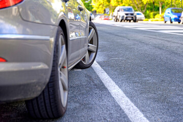 Car parked across solid white line parked on sealed road