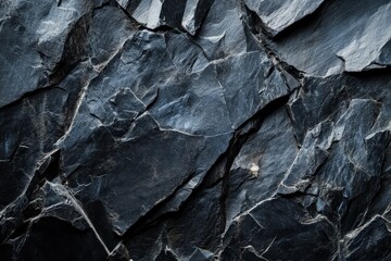 Dark textured slate rock surface with fine details.