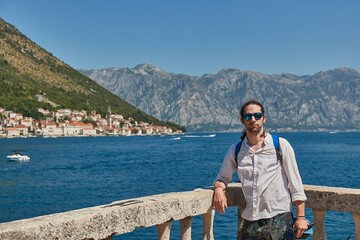 Man standing on an island in Kotor Bay, Summer vacation