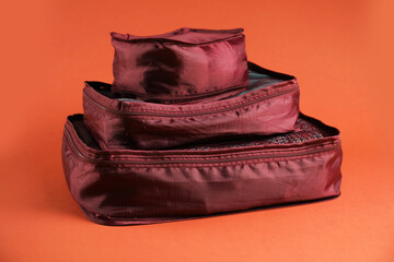 Packing cubes with clothes on bright orange background