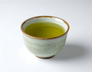 A white ceramic teacup with hot japanese green tea and a slice of lemon is an isolated healthy breakfast drink