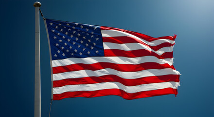 Obraz premium American Flag Waving Proudly Against A Bright Blue Sky Representing National Pride and Freedom