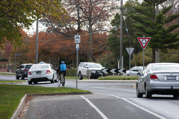 cyclist signaling while turning right in a roundabout