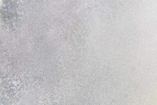 Textured surface of frost covering an outdoor landscape during winter