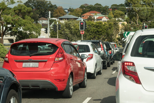Cars stopped at red traffic lights in urban traffic in daylight