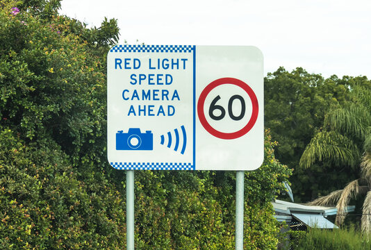 Red light speed camera ahead warning sign and 60 sign