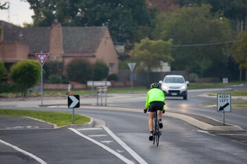 Cyclist approaching a roundabout in the evening