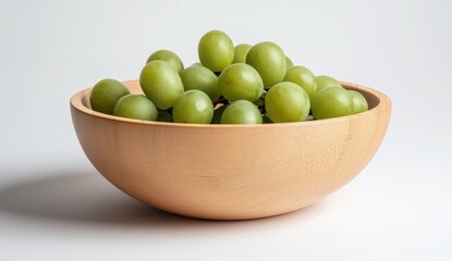 Green Grapes in a Textured Beige Wooden Bowl on White