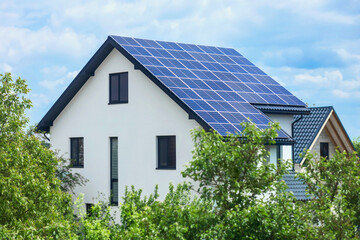 Solar Panel Roof House with Green Big Garden. Solar Energy Station on Roof Building. Photovoltaic Roof Installation.