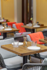 Served tables in a summer street restaurant. Atmosphere of coziness and beauty.