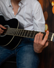 Fototapeta premium man hands playing guitar