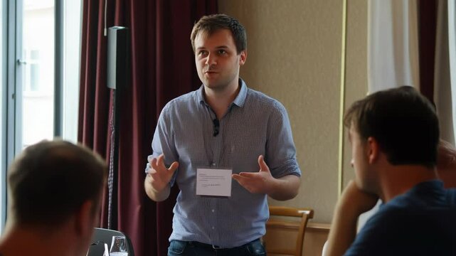 A presenter in a conference room engages attendees with a dynamic and informative talk.