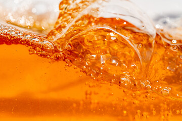 Close up bright orange Oil or beer splash texture and nature waves, Beautiful waves curve and little bubbles smooth for graphic design and background, Oil Bubbles, Soft beer bubbles, Selective focus