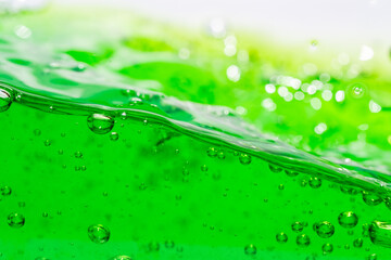 Water wave, close up of vibrant green liquid with bubbles, capturing dynamic movement and...