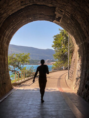 Silhouette of a man walking through a tunnel on the embankment in Herceg Novi © tashka2000
