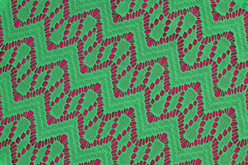 Fototapeta premium green fabric with geometric lace pattern. abstract geometric background