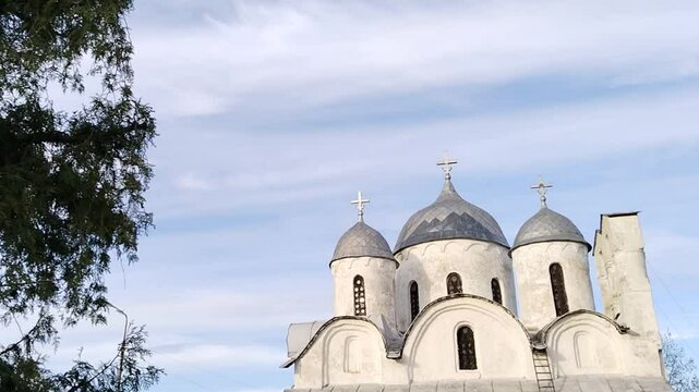 Ancient orthodox christian Cathedral of Ioann Predtecha (John the Precursor). Church located in Pskov, Russia. Russian temple. Old architecture. Cross. Christ is Risen. Travel. Scene. Blue sky. Heaven