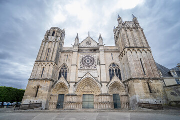 Fototapeta premium Poitiers Cathedral imposing facade rising under cloudy sky in France