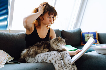 young woman spending time with her cat