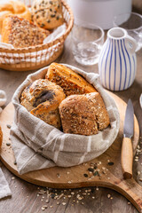 Naklejka premium Assortment of bread, rolls and bakery products with salt, butter and seeds