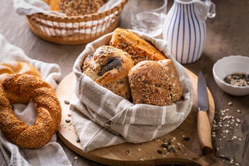 Assortment of bread, rolls and bakery products with salt, butter and seeds