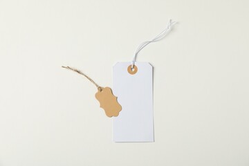 Blank tags with strings on white background, top view