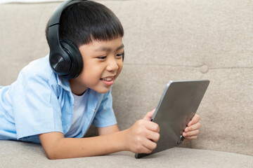 Back to School: Young Boy Engaged in Learning with Tablet and Headphones