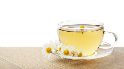 Delicious chamomile tea in cup and fresh flowers on wooden table against white background