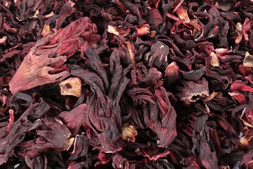 Hibiscus tea. Dried roselle sepals as background, top view