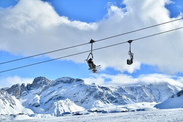 Ski lifts and skiers on the slopes Courchevel ski resort by winter