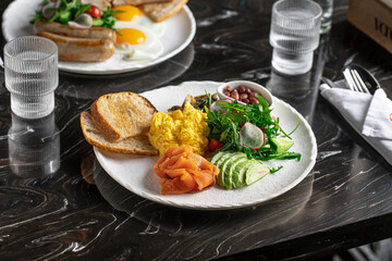 Set breakfast with scramble egg fish and avocado
