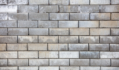 A brick wall with a grey color