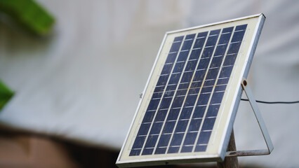 Solar panel on a stand, showcasing renewable energy technology outdoors.