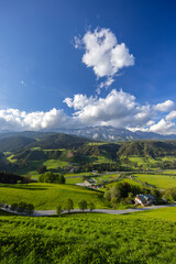 Obraz premium Dachstein Glacier towering over Schladming valley in Styria, Austria, during a sunny spring day