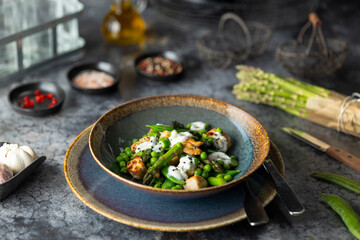 Enjoying a healthy meal of chicken, asparagus and peas with yogurt sauce