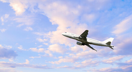 Airplane flying in the sky, summer travel background with flying airplane