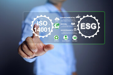 Environmental social governance concept with businessman pointing on iso 14001 to driven company's policy determination in line with environmental policy guidelines and regulations