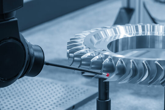 The multi axis CMM machine measure the gas turbine engine parts in the light blue scene.