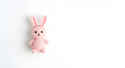 Obraz premium Pink Toy Bunny Rabbit Stands Against White Backdrop Studio Shot