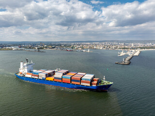 Large container ship leaving port. Aerial view of cargo container ship vessel import export...