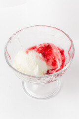 A tempting bowl features two scoops of rich vanilla ice cream topped with sweet cherry sauce