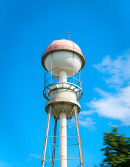 Majestic water tower beneath a vast azure sky, Dynamic motion. with white shades